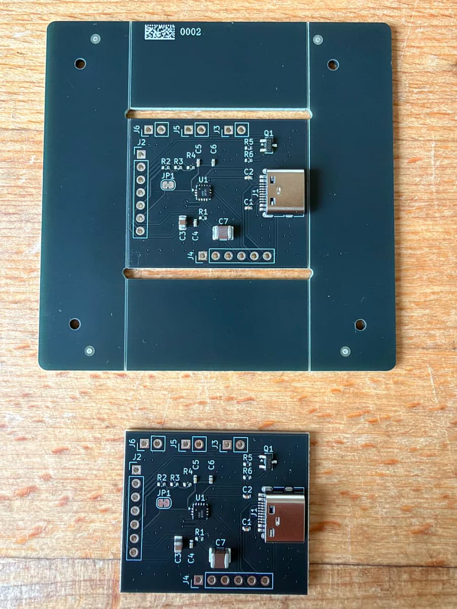 Front of the FUSB302B breakout boards, one still in the snap-out panel and one separated