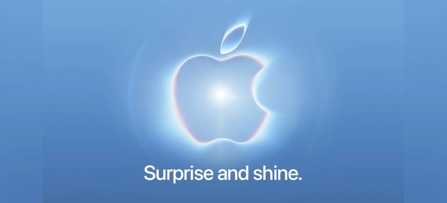 Apple's Surprise and Shine event artwork: a glowing Apple logo on a blue background above the words Surprise and shine